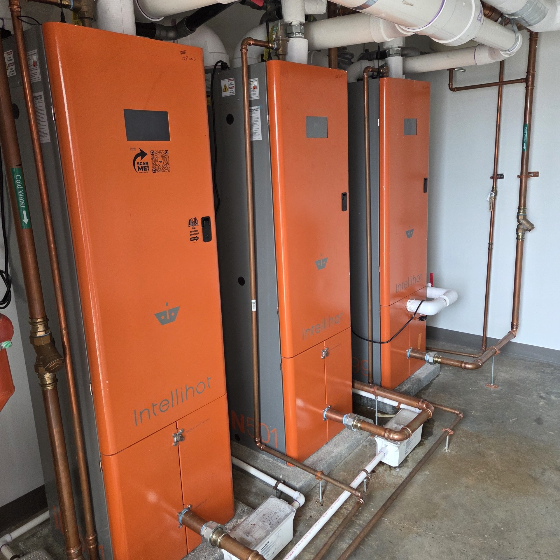 Intellihot commercial water heater units installed in hotel mechanical room
